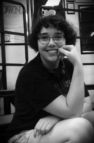 Emily poses for the camera in the choir room. Photo courtesy of Brynn Jackson.