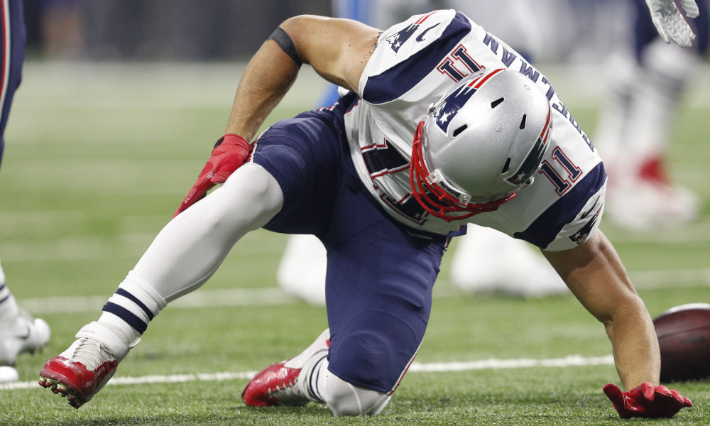 New England Patriots wide receiver Julian Edelman (11) holds his leg in pain after a play during the first quarter against the Detroit Lions at Ford Field. Raj Mehta-USA TODAY Sports