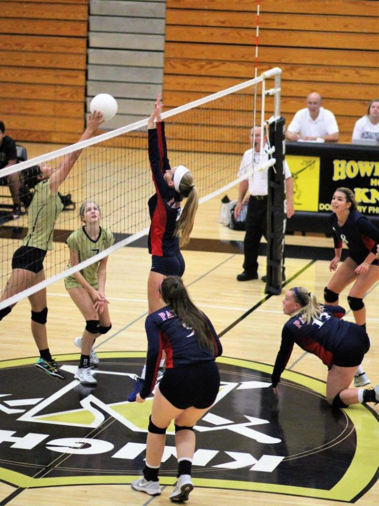 Senior Bri Whitener blocks an attempt from her opponent during a recent volleyball game.