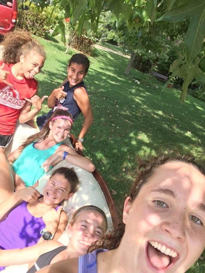 Varsity cross country runners take a selfie on a discarded couch while on a run. 