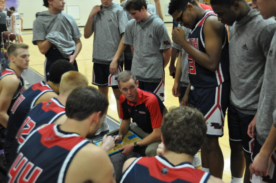 Coach Matt Roach discusses team strategy during a break in the action against West, Nov. 27.