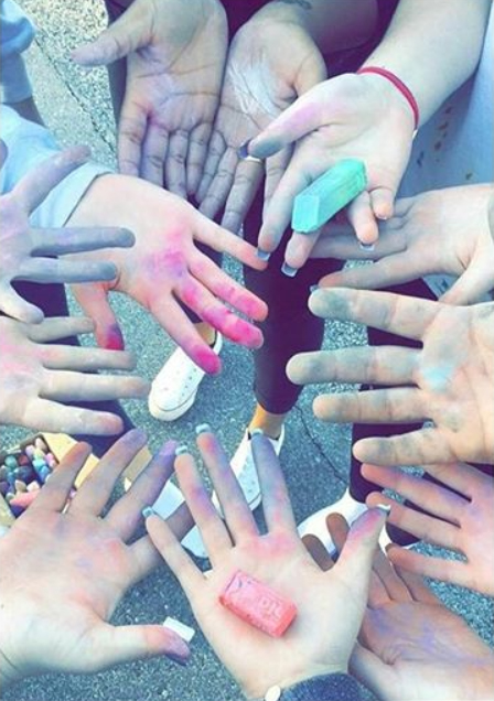 Students+show+their+messy+hands+after+chalking+the+parking+lot+during+last+years+Kindness+Week.