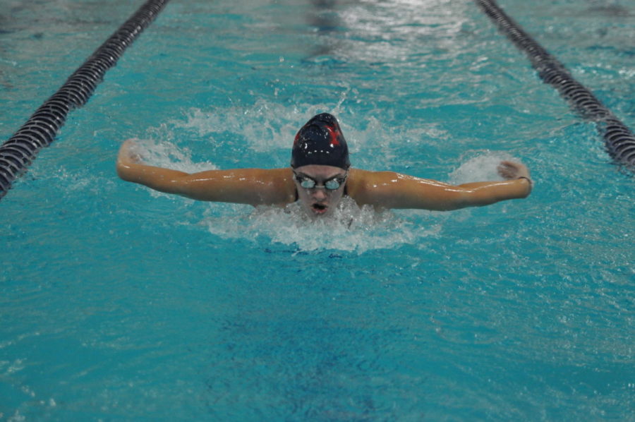 Sophomore Adelle Simmons reaches for the water while doing the butterfly.