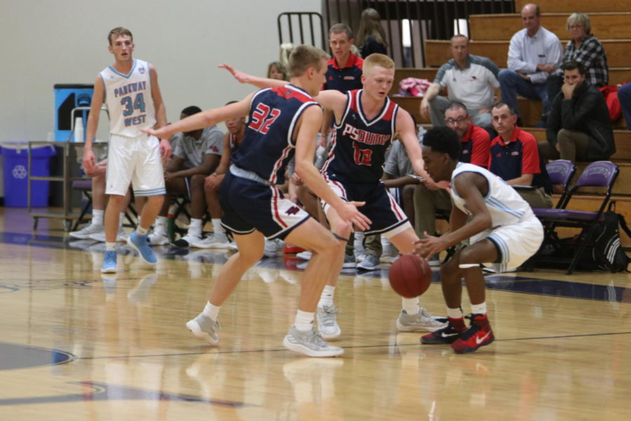 AJ Sommer and Adam Sommer play defense in a game against Parkway West. The Patriots beat the Longhorns, 69-31
