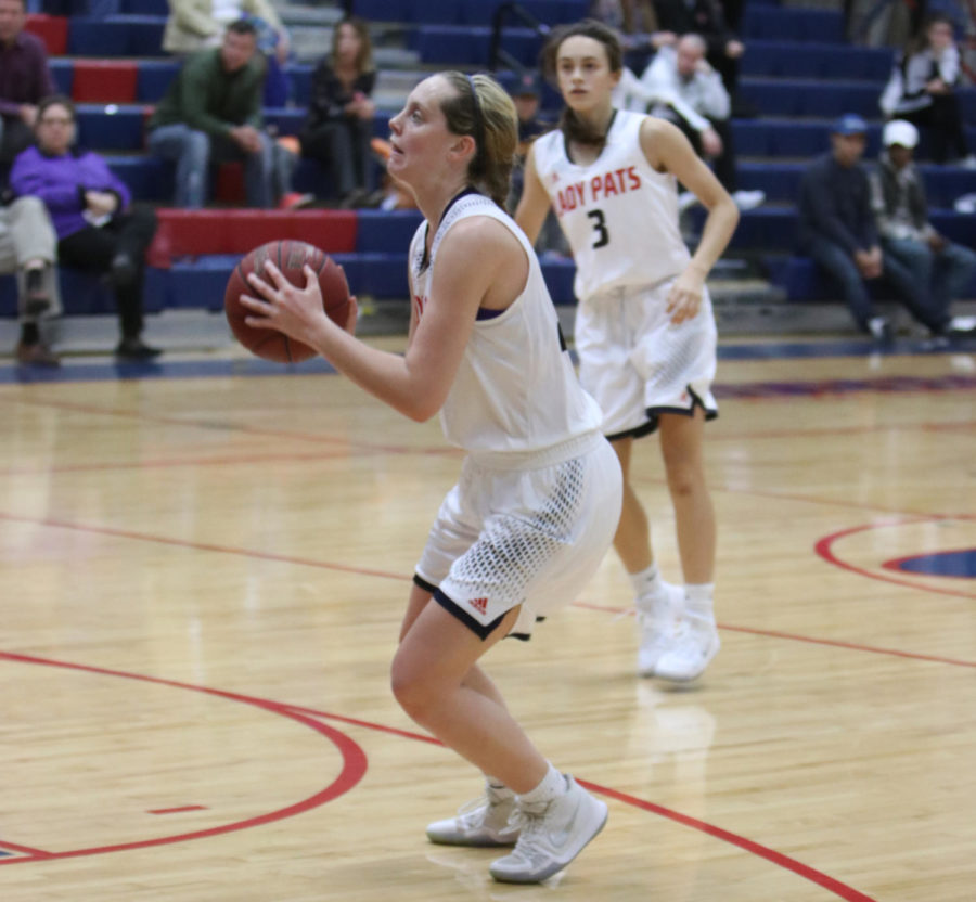 Junior guard Lani Thompson eyes the basket, ready to shoot. 