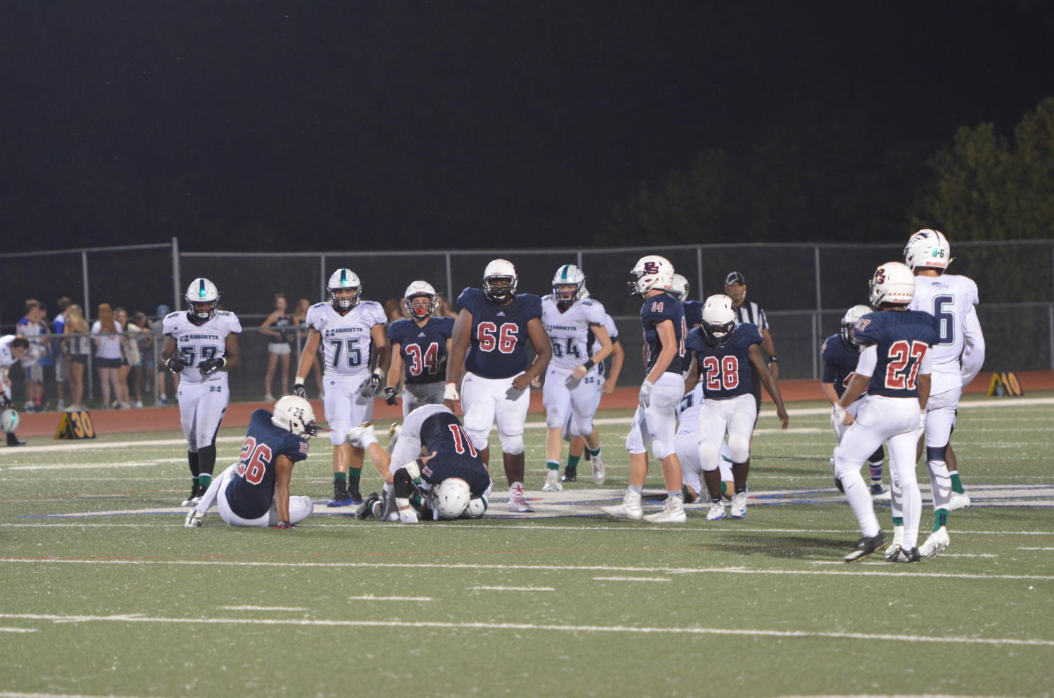 Linebacker Joe Audiffred tackles a Marquette player during the game last weekend. The Patriots lost to the Mustangs, 49-0