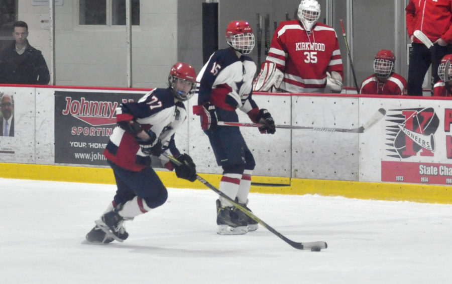 Senior Henry Kasten looks up the ice for someone to pass to during the game against Kirkwood. Kasten leads the team in goals with 9 so far this season.