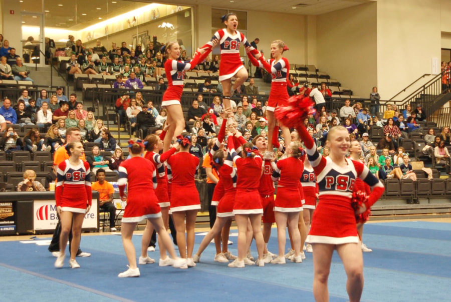 Junior flyer Jenna Watson tops the pyramid in the varsity cheerleading state routine at Lindenwood University. 