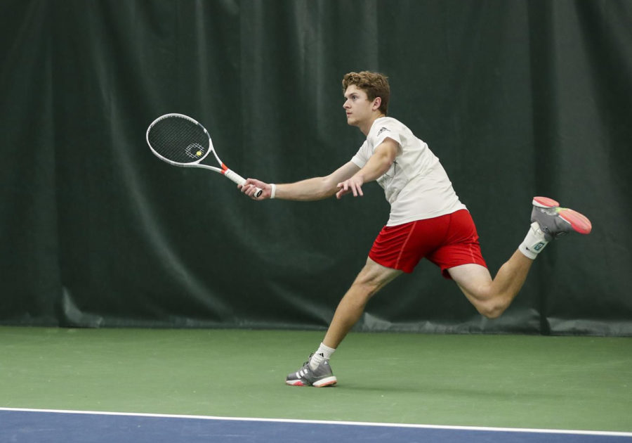 #3 singles player Carson Haskins hits a forehand during a win over Drake University, Feb. 16. 