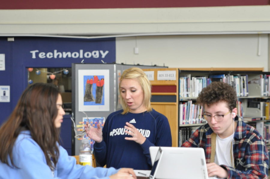 Melissa Gebhard works with sophomores Paige Mancuso and Philip Oakley in the library during Histolish.