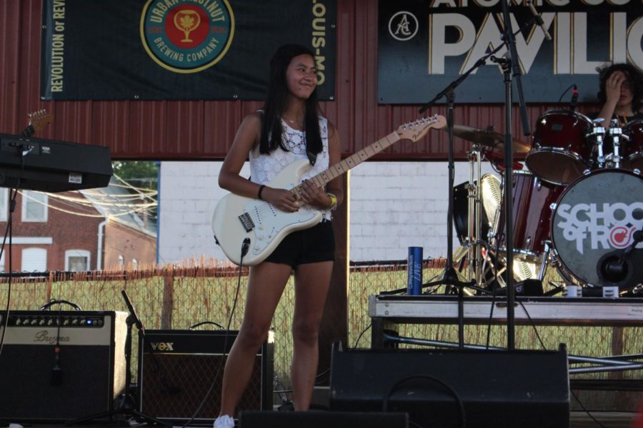 Junior Jessie Murphy plays the guitar at one of her gigs.