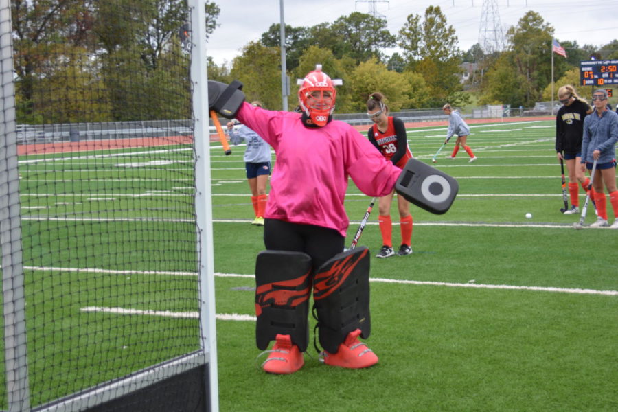 Senior Paige Kuhnmuench takes a break while playing goalie for the field hockey team.