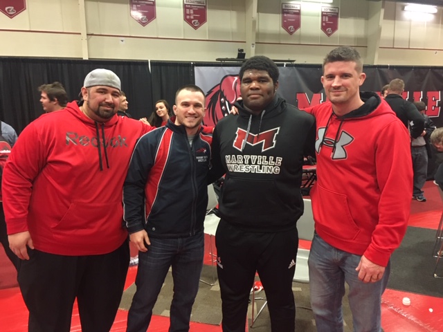 Former wrestling coach Jim Lake visits Donnell Walker at a wrestling practice at Maryville University.