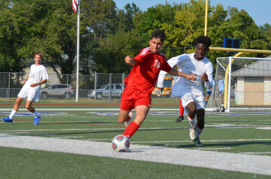 Sophomore+midfielder+Arya+Sabourizadeh+tries+to+keep+the+ball+in+bounds+while+getting+away+from+his+Parkway+West+opponent.+