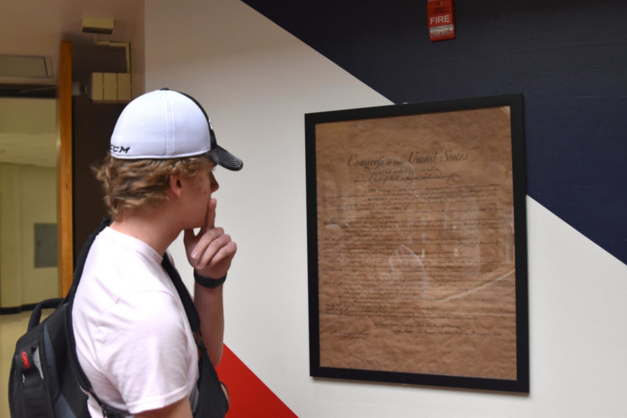 Junior Jason Gifford studies a copy of the Constitution displayed in South High