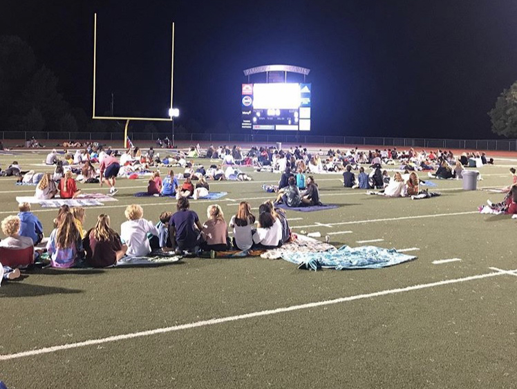People gather on the football field to watch Ferris Buehlers Day Off. This was an activity planned by the PREPS.