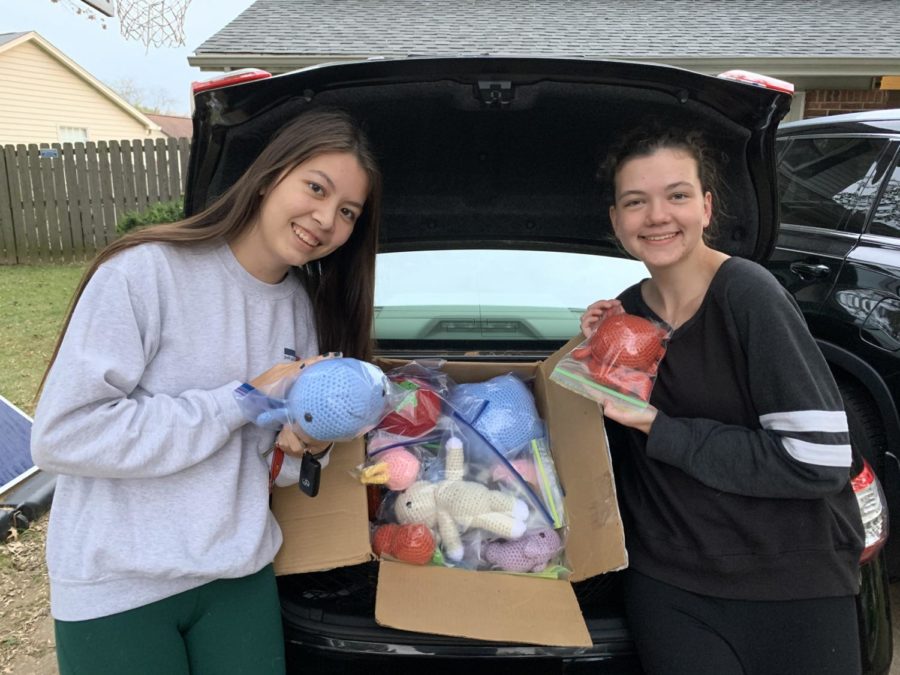 Seniors Alexa Spoerle and Katie Wilson display two of the many homemade stuffed animals theyve stitched for sick children.