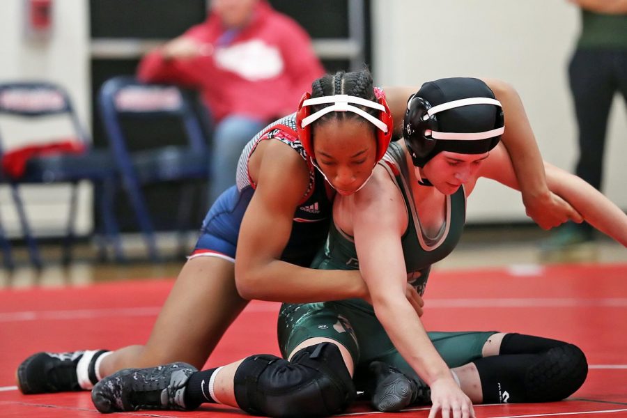 Freshman Janiah Jones attempts to get her LIndbergh opponent to the ground during her match, Dec. 4. Jones earned her first pin ever in the match. 