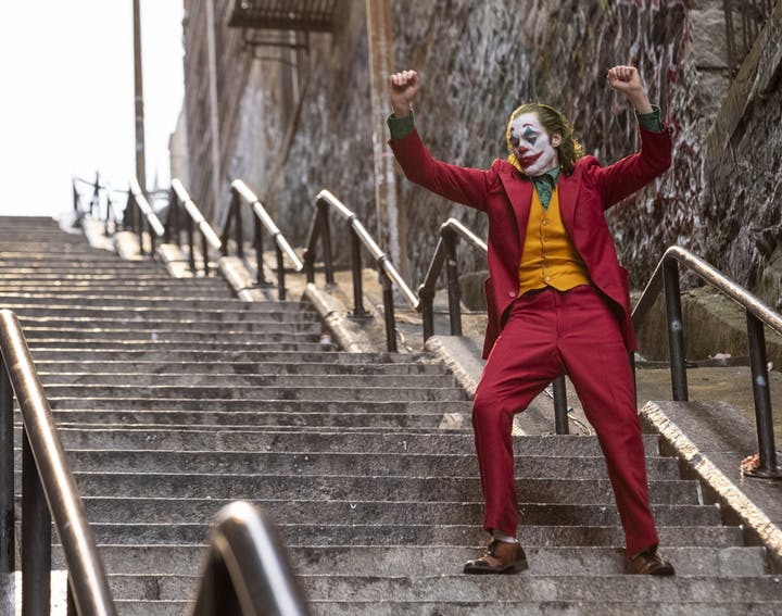 Joaquin Phoenix dances down the staircase in Joker.