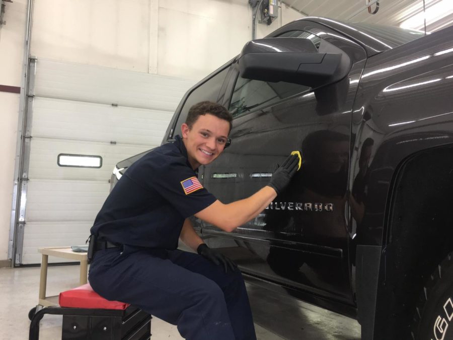 Senior Luke Ramsey works on buffing out a customers truck.