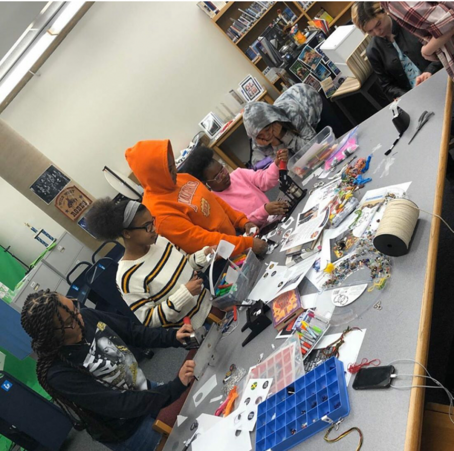Junior Anaya Willis, sophomore Zakiyah Willis, sophomore Hope Doyle,  junior Khaeleana Minton, and sophomore Aris Owens work on crafts in the library during Black History Month.