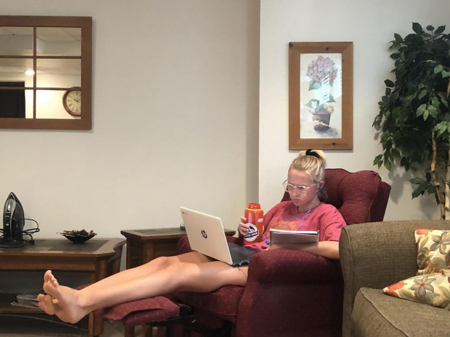 Senior Lauren Bles does her online learning in her living room recliner.