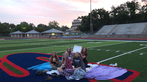 Seniors Sophia Auberry, Jordan Medlock, Anna Kornfeld, Emma Kauffman, and Lindsey Storey celebrate Stephanie Hookers birthday on the 50 yard line at 5 a.m.