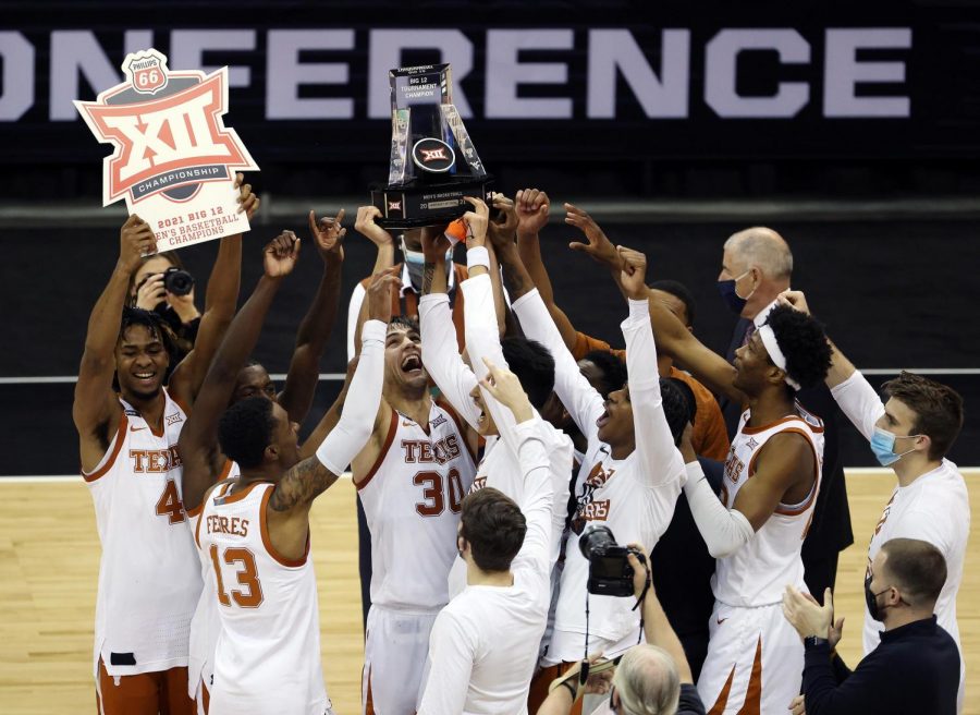 The+Texas+Longhorns+celebrate+after+a+91-86+triumph+against+Oklahoma+State+in+the+Big+12+Tournament+championship+game+at+the+T-Mobile+Center+in+Kansas+City%2C+Missouri%2C+on+March+13%2C+2021.