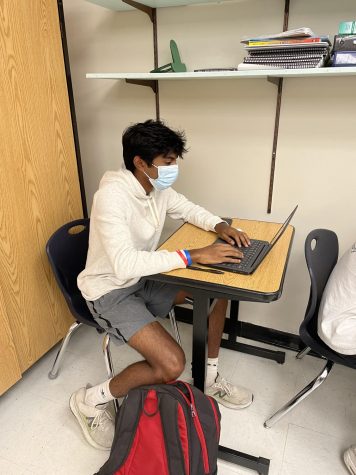 On a purple day, junior Srujan Garimella works on his Chromebook in Mr. Taylors English 3 class.