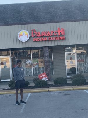 Junior Srujan Garimella stands outside his dad's restaurant, Bawarchi Indian Cuisine.