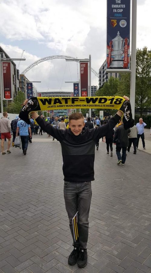 Connell takes a picture at Webley Stadium at an FA Cup Final football match.