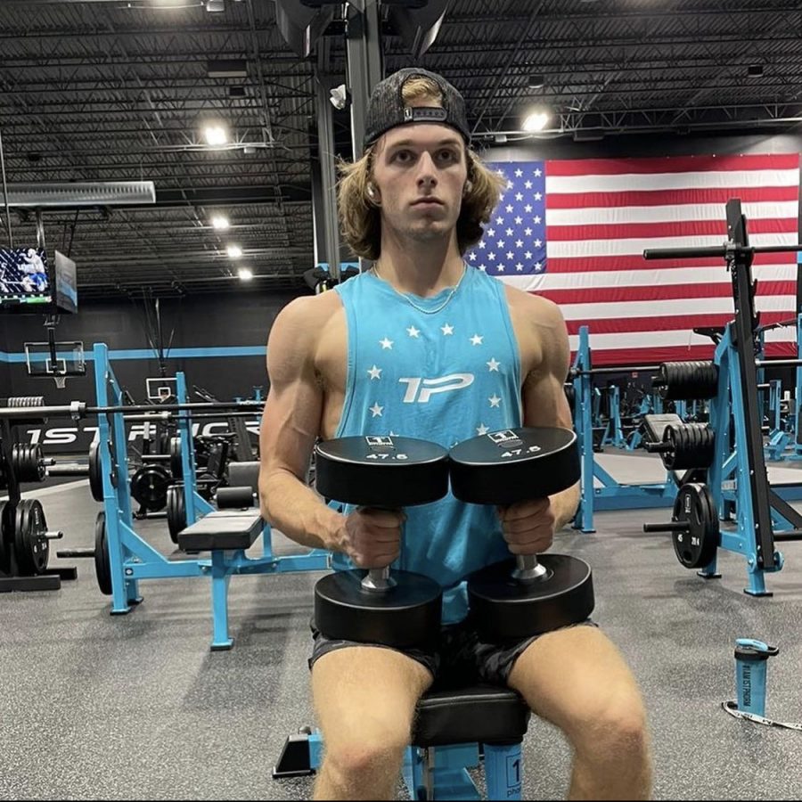 Senior Mikey Sapienza gets ready for an intense shoulder press set at his gym, First Phorm headquarters.