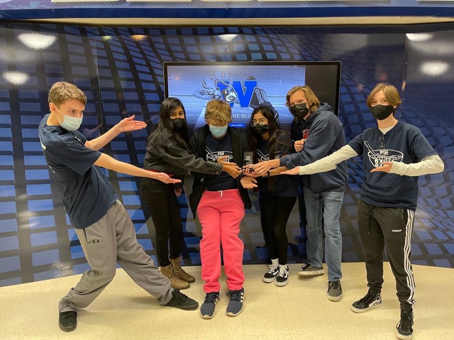 Scholar Bowl team members Jacob Dickerson, Maanvi Aggarwal, Owen Walaitis, Sylvene Farooq, Reese Rich and Alaska Alcaraz hold up their trophy after taking 3rd in the Washington High School tournament.
