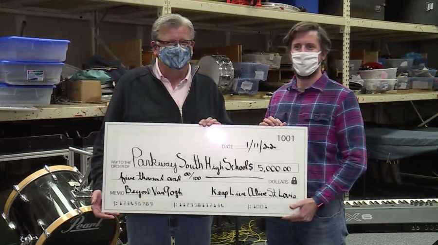 Keep Alive St Louis board member, Greg Hagglund presents a $5,000 check to South High Band teacher, Matt Wall.
