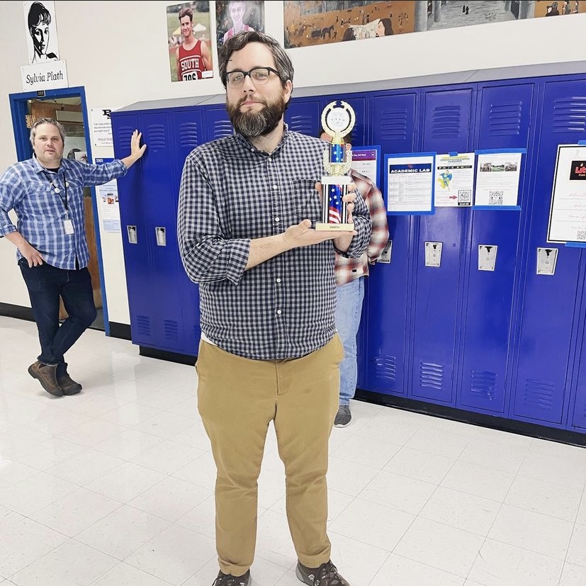 Social Studies teacher Pete Wissinger holds his trophy after beating his brother in Marshmallow Madness.