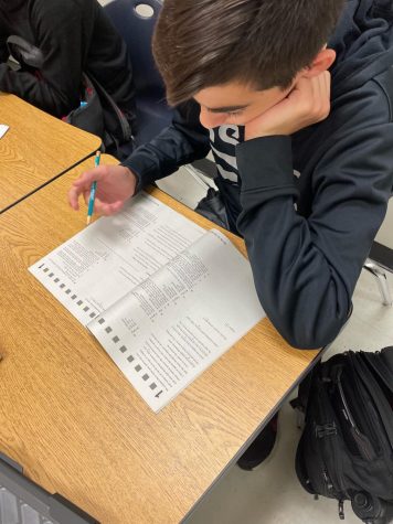 Freshman Jacob Moretti looks over a practice ACT booklet to familiarize himself with the test.