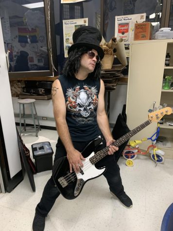 Art teacher Eric Ludlow poses as Slash, the lead guitarist from Guns N Roses.