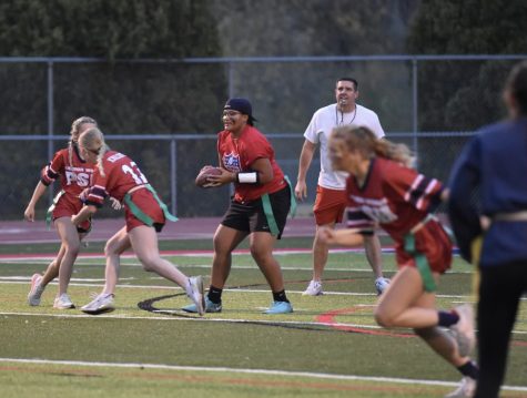 Quarterback Annalise Dorr gets the snap from Caroline Knolhoff and looks downfield to pass during the Powderpuff game. 