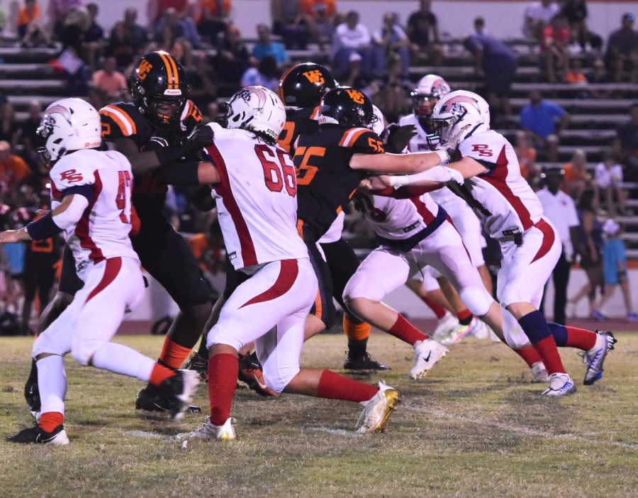 #66, senior Kyle Brown, fights off a Webster Groves tackle to get to the quarterback. 