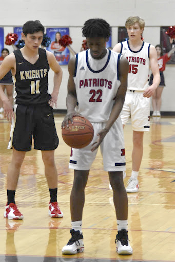 Senior Jaylen Calloway takes a few dribbles before concentrating on his free-throw shot in a game last season. 