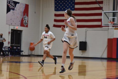 Senior guard Annalise Dorr dribbles up the court, while sophomore Ava McCulla looks to receive the pass in a game last year.