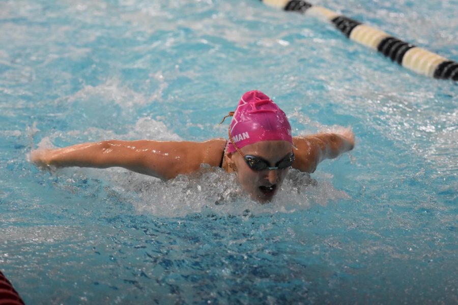 Senior Mia Muckerman raises herself out of the water to breathe while swimming the Butterfly. 