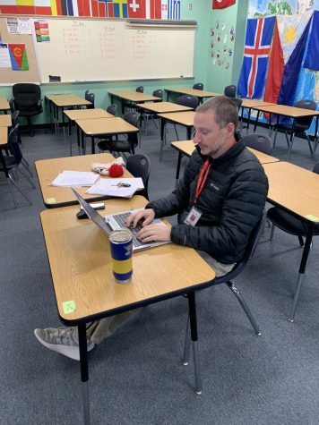 History teacher Adam Weiss works on catching up on grading on his plan period. 