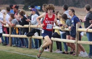 Sophomore Andrew Rebholz kicks toward the finish line at the state cross country meet.