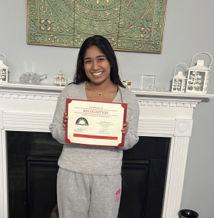 Senior Anushka Rawat poses with a certificate of recognition given to her by the Parkway district for her selection to the Youth Senate program.