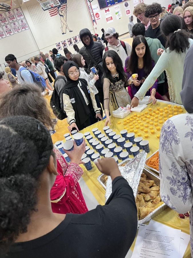 Sophomores Shafwa Budiman, Amna Iqbal and junior Sonia Akbani help to serve food during the last Culture Day.