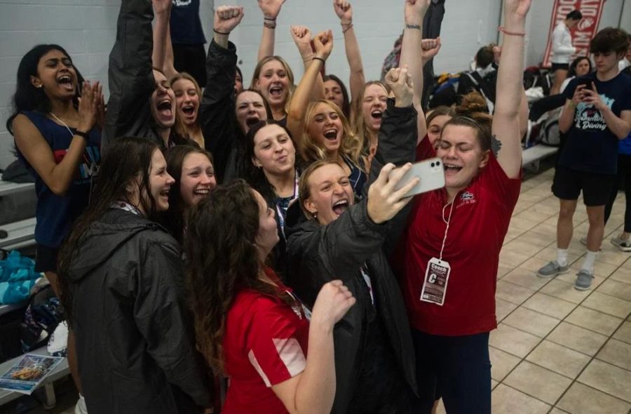 The+girls+swim+team+celebrates+with+a+group+selfie+after+claiming+the+Class+2+Swimming+State+Title+again+this+year.+