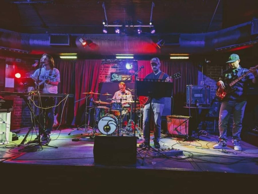 Music teacher Matt Wall (far left) sings and plays along with his band, DadBod, at a recent gig.