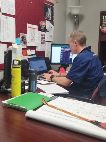 Athletic Director Matt Roach works at his desk on Monday. Potential open-enrollment legislation could allow athletes to move to schools with better teams.