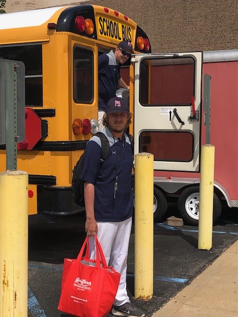 Mr. Mertz stops for a quick picture before he boards the bus to head to a JV baseball game. Photo by Sofie Bertanjoli.